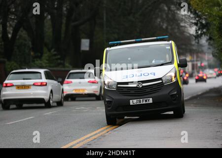 A Police van parked on the side of the road. Stock Photo