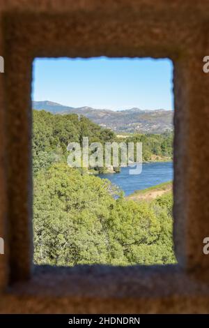 Vertical shot of nature view from a castle window on a sunny day Stock Photo