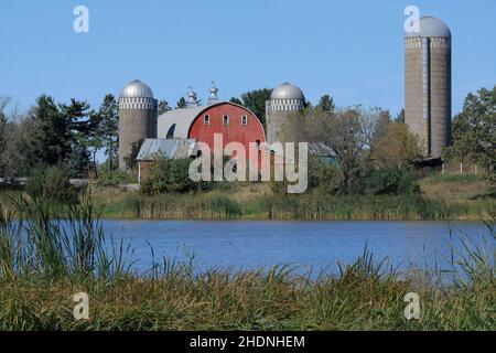 Farm with a red barn and silos on Lake Martha in Chisago City, Minnesota USA in the autumn of the year. - Sept. 26, 2012 Stock Photo