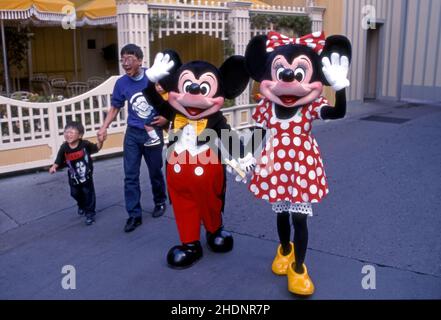 Visitors with costumed characters of Mickey Mouse and Minnie Mouse at the original Disneyland in Anaheim, California, USA. Stock Photo