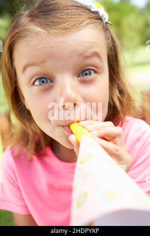 Girls at birthday party with party blowers Stock Photo - Alamy