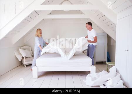 happy, couple, making bed, happies, couples, cleaning bed, making beds Stock Photo