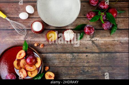 Preparing dough for plum cake on wooden table. Flat lay. Stock Photo