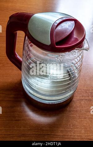 Glass electric kettle with blue LED lighting close-up. Stock Photo