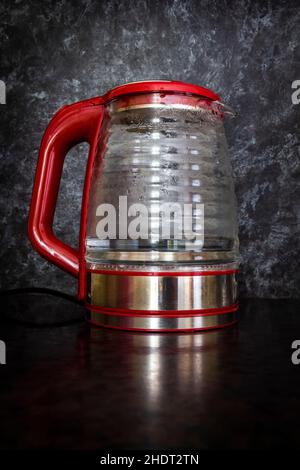 Glass electric kettle with blue LED lighting close-up. Stock Photo
