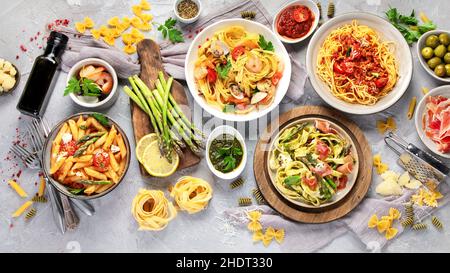 Pasta assortment on gray background. Traditional Italian Food concept. Top view, flat lay Stock Photo
