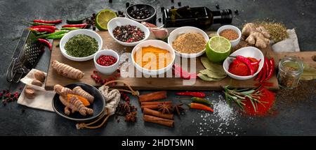 Assortment of spices on gray background. Traditional seasoning concept. Stock Photo