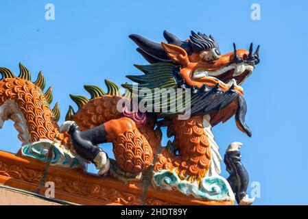 Painted dragon statue on the roof of traditional Chinese ancient building Stock Photo