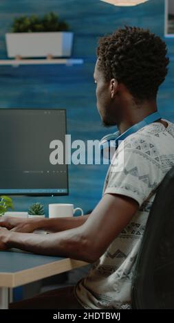 Programmer using binary code for website interface development on computer. Person coding system for cybersecurity with firewall data. Coder programming security for software app Stock Photo