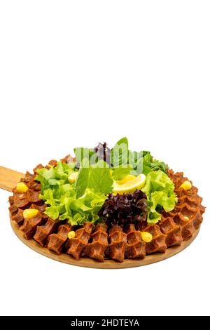 Raw meatballs (cig kofte) isolated on a white background. Traditional Turkish cuisine delicacies. Vertical view. Close up Stock Photo