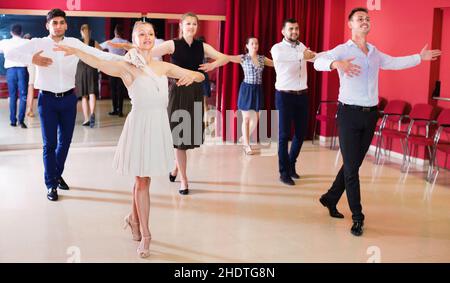 People practicing passionate samba in dance class Stock Photo