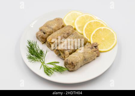 Stuffed cabbage leaves, in a ceramic plate. Vegan cabbage rolls, cooked cabbage leaves, wrapped around a filling of rice, onions and spices. (Lahana s Stock Photo