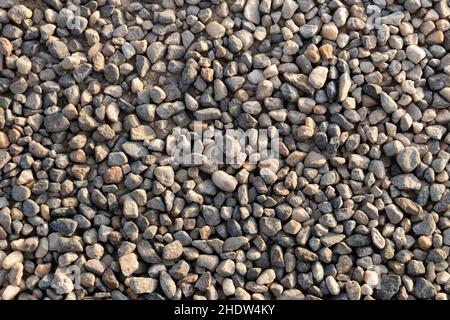 compact soil composed of medium-fine gravel, sunset light, perpendicular view Stock Photo