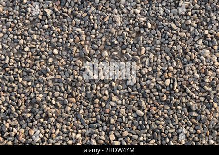 compact soil composed of medium-fine gravel, sunset light, perpendicular view Stock Photo
