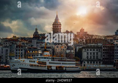Galata Tower, located in the Beyoğlu district of Istanbul, with its magnificent sunset view embodying an epic spirit. Stock Photo