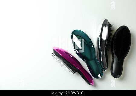 Colored plastic hair brushes on white background Stock Photo