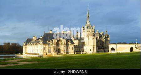 Domaine de Chantilly, Chantilly Castle in a ray of light. Famous tourist destination near Paris. Stock Photo