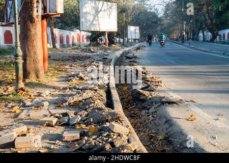 A close-up shot of dug-up drainage alongside the road. Under-construction drainage alongside the road in India. Stock Photo