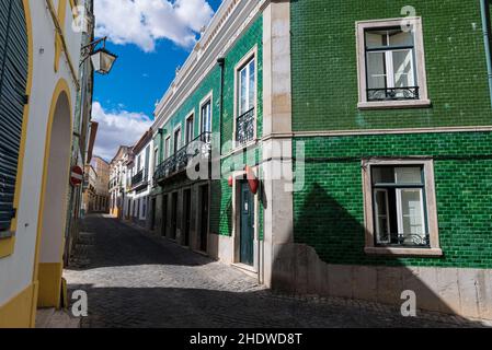 House with green ceramic tiles (azulejo's) in a narrow cobbled street in Beja, Alentejo, Portugal Stock Photo