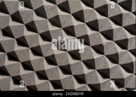 perpendicular view of a gray pyramidal sound-absorbing foam panel, shadows at 45 degrees Stock Photo