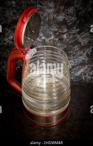 Glass electric kettle with blue LED lighting close-up. Stock Photo