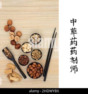 Chinese herbs used in natural and alternative medicine on bamboo with calligraphy script. Translation reads as traditional apothecary Chinese herbs. Stock Photo
