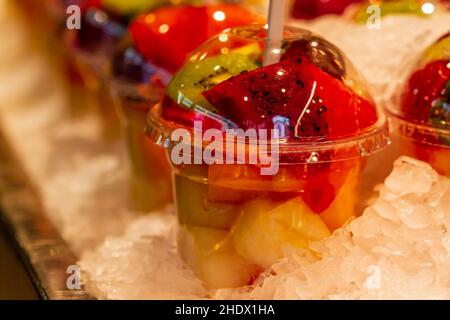 Closeup shot of plastic cups with fruit in ice at a market Stock Photo