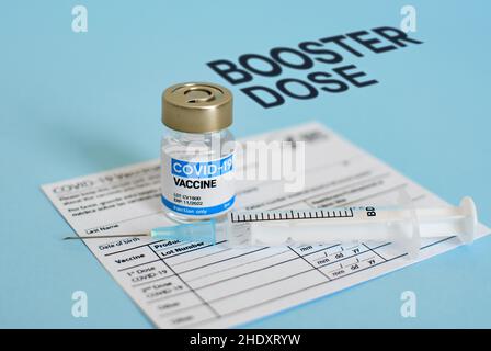 Close-up image of vaccine vial and syringe on CDC covid-19 vaccination record card. Stock Photo