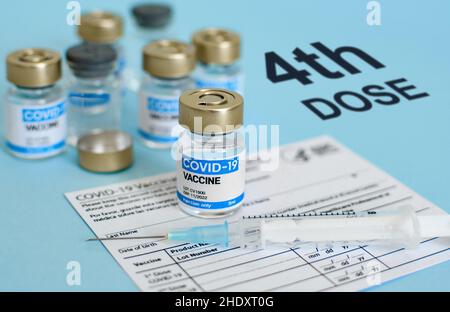 Close-up image of vaccine vial and syringe on CDC covid-19 vaccination record card. Stock Photo