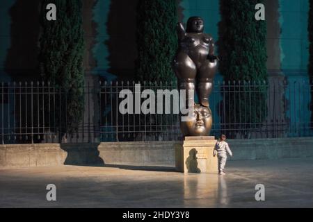 Fernando Botero Sculpture in Medellin Colombia at night next to an unattended child Stock Photo