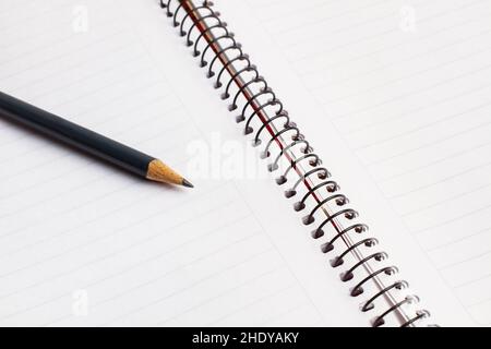 A blank notebook and a pencil in a close up view Stock Photo