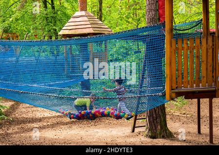 Boy climbing on a obstacle route Stock Photo