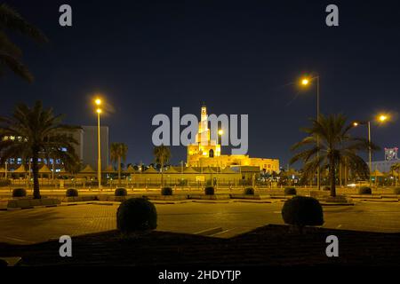 Cityscape old town of Doha, Qatar with Al Fanal building and Qatar Islamic Cultural Center against dark sky at night Stock Photo