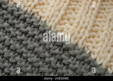Knitted pattern of threads in two colors grey and white. Stock Photo
