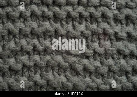 Dark grey knitted background, thread pattern. Stock Photo