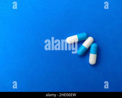 Top view pills capsules with copy space on blue background.Selective focus. Stock Photo