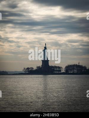 The colossal Statue of Liberty on Liberty Island in New York Harbor Stock Photo