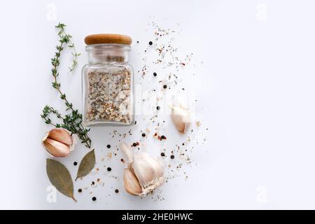 Different spices and garlic on light grey background, top view. Stock Photo