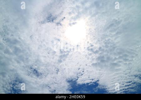 Bright Sunbeam Shining Among Fluffy Altocumulus Clouds Stock Photo
