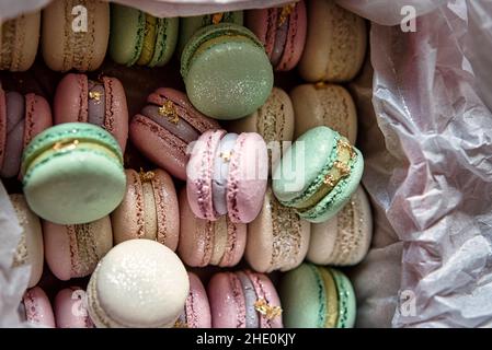 French macaroon cake. Macaroons in box with dried flowers on white background flat lay. Stock Photo