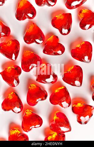 Full Frame Image of Sparkling Red Faux Gemstone Hearts on a White Studio Background Stock Photo