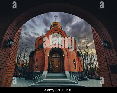 Church of St. George the Victorious in the arch against the background of the evening sky Stock Photo