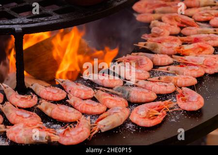 Process of grilling red king prawns on brazier with hot flame Stock Photo
