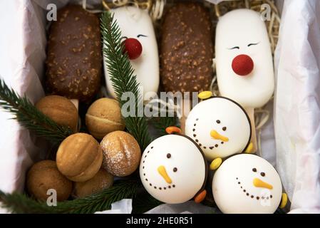 Christmas sweets and cookies. Box with tasty Christmas cookies on wooden table Stock Photo