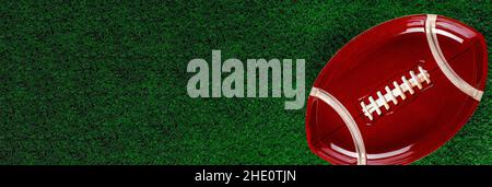 Banner with american football plate on green grass background. Stock Photo