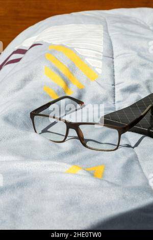 stylish glasses on a closed notebook with light blue background, lifestyle and intellectual hobbies, reading and accessories Stock Photo