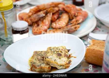 fried king prawns and cod fillet on plate closeup Stock Photo