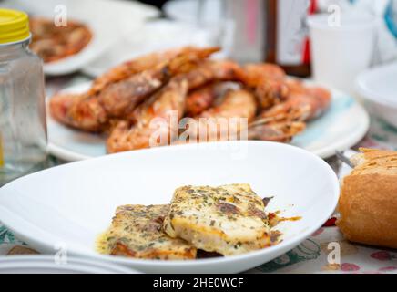 fried king prawns and cod fillet on plate closeup Stock Photo
