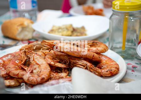 fried king prawns and cod fillet on plate closeup Stock Photo