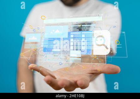Male's hand holding an illustration of an interface web application Stock Photo